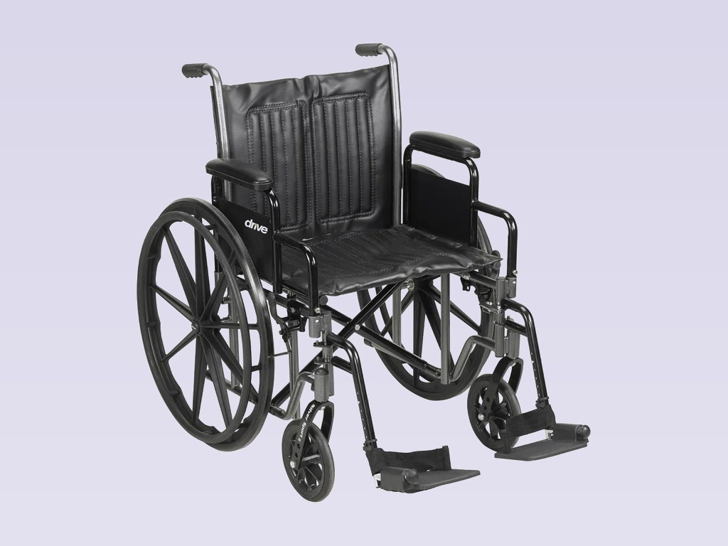Standard manual wheelchair with padded armrests and swing-away footrests